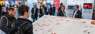 A visitor checks the exhibitor list at SIFER